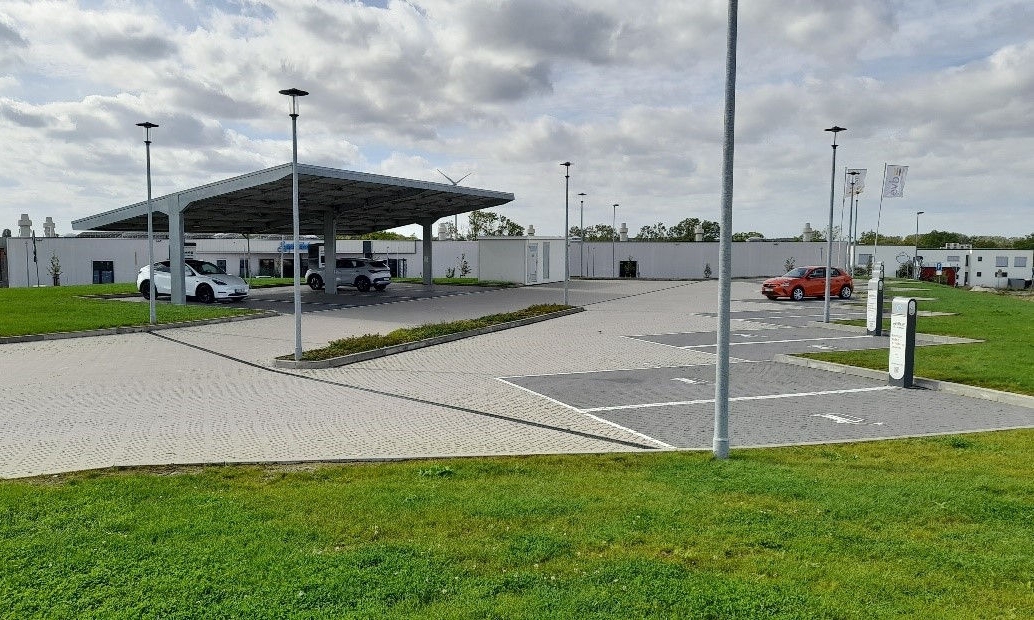 Parking lot with a solar roof, charging stations, and parked cars