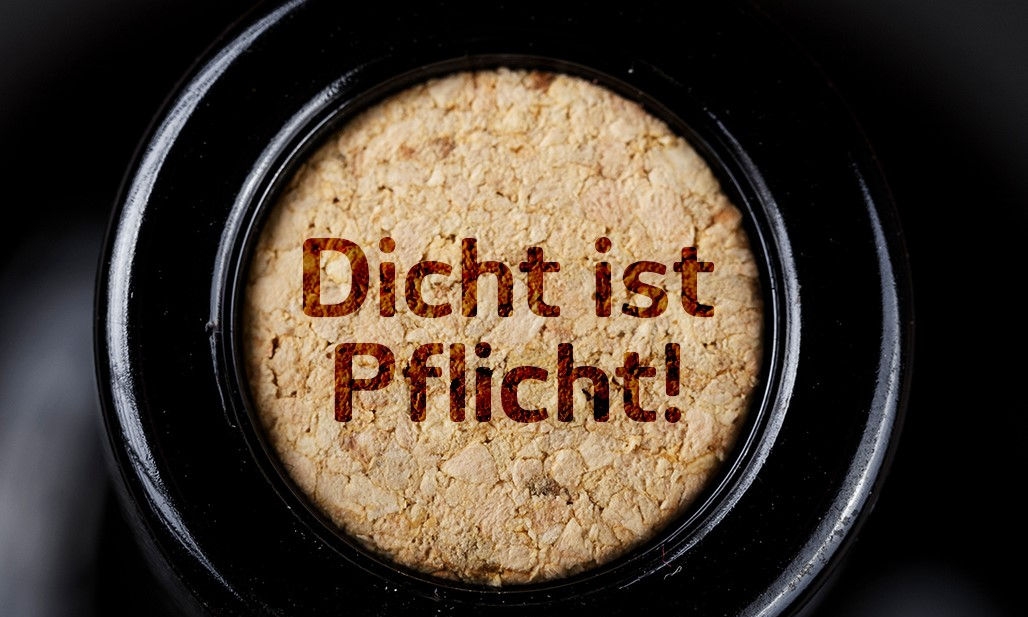 A cork sealing a wine bottle with the words "Dicht ist Pflicht!" written on it